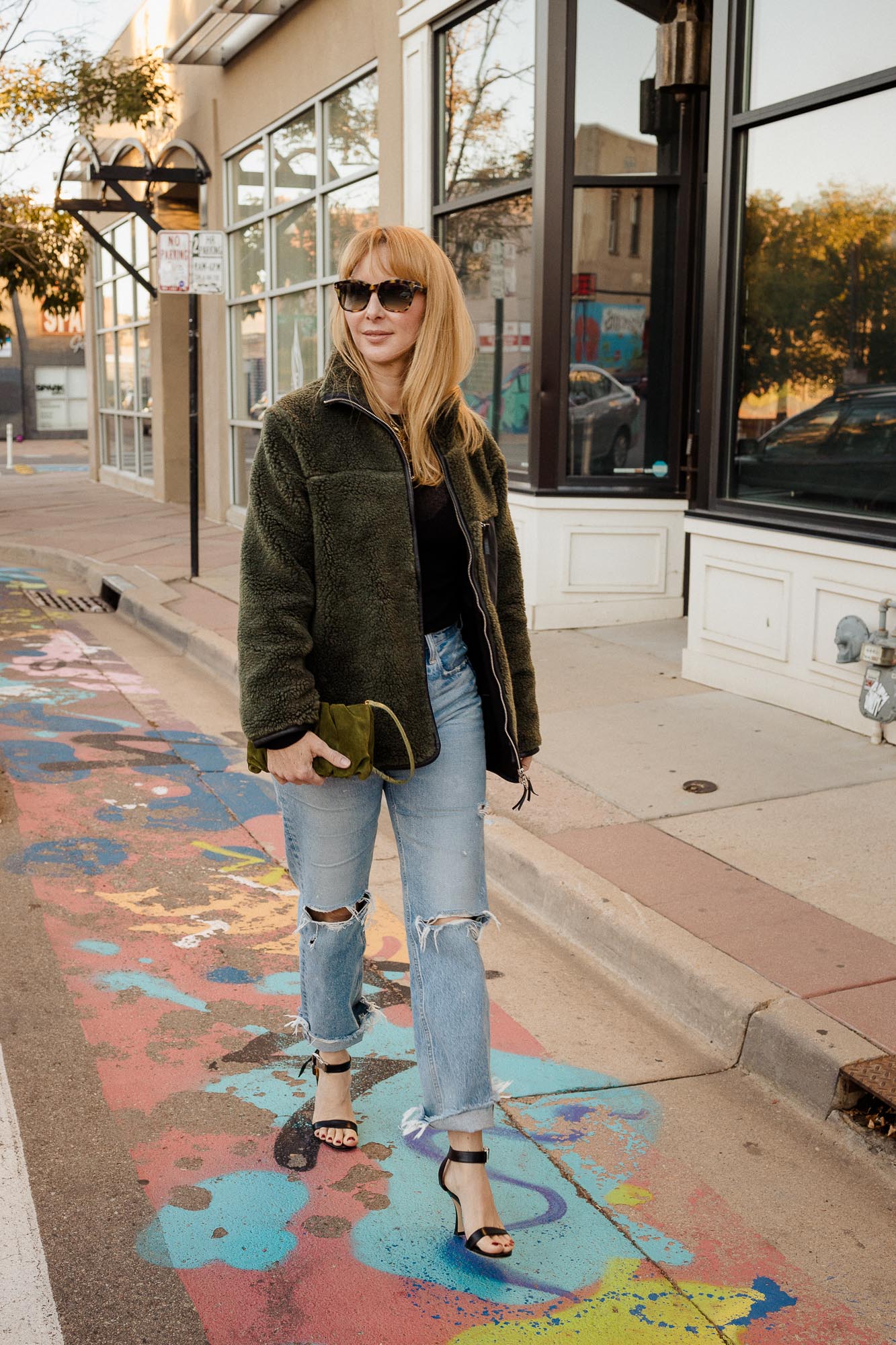 Wearing the Anine Bing Ryder jacket with Moussy jeans and an olive Staud bag and black heels.