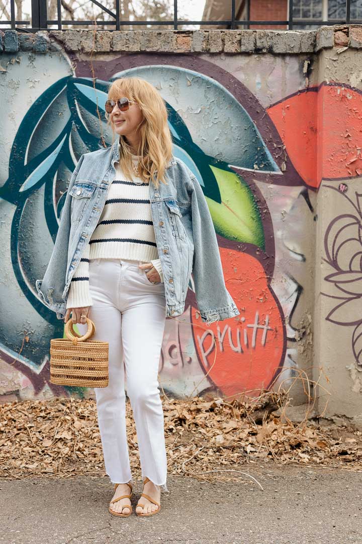 Wearing the Anine Bing Rory denim jacket with a striped Le Ligne sweater, white MOTHER Hustler jeans, K Jacques sandals, and the Cult Gaia Coco mini tote.