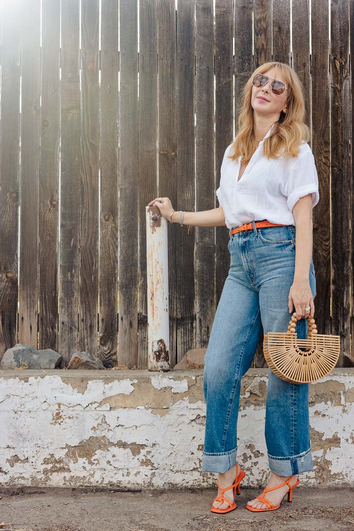 Orange accessories to wear - the XiRENA Cruz shirt in white with MOTHER tunnel vision jeans, and Frame belt and heels in the color orange crush.