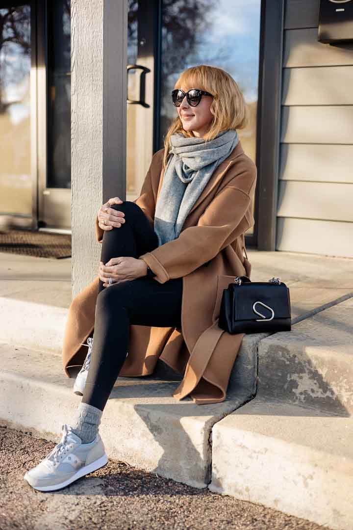 How to look good in loungewear with Saucony original sneakers, Vuori leggings and the camel Anine Bing Dylan coat.