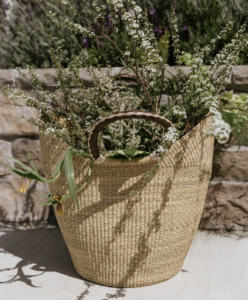 Jenni Kayne Woven tote full of Spring flowers.