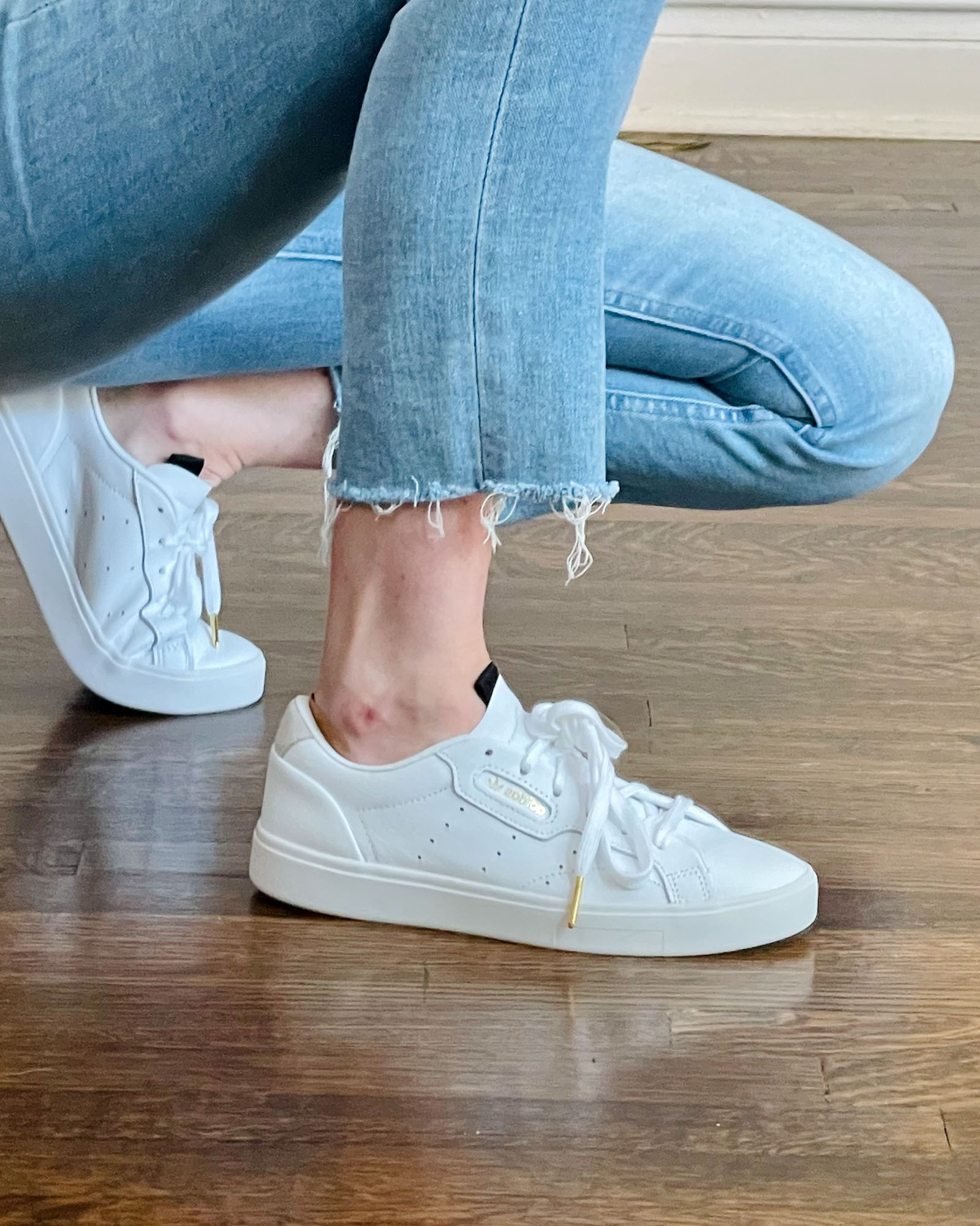 Showing the Adidas Sleek sneakers in white.