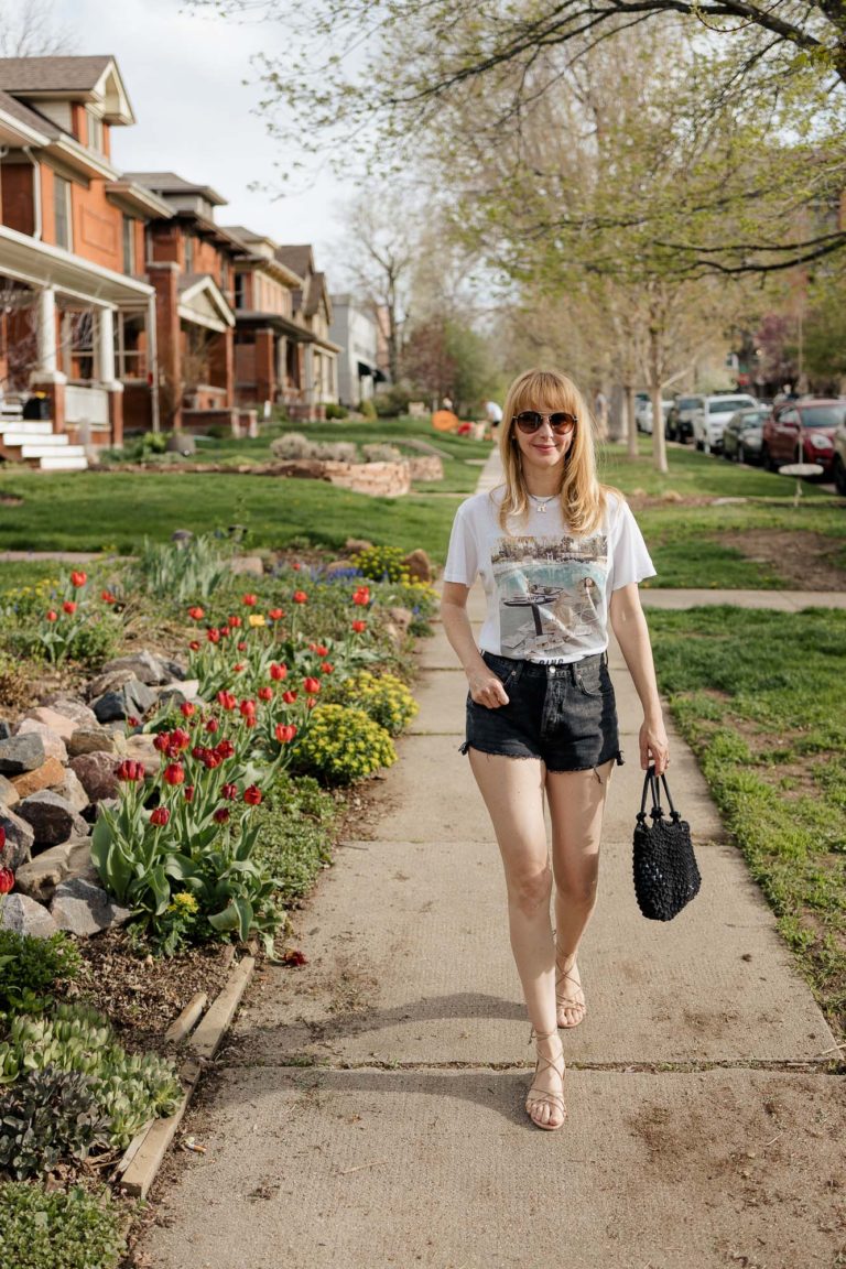 Walking past tulips in the Anine Bing graphic tee Lili with my washed black Agolde cutoff shorts and nude lace up sandals.