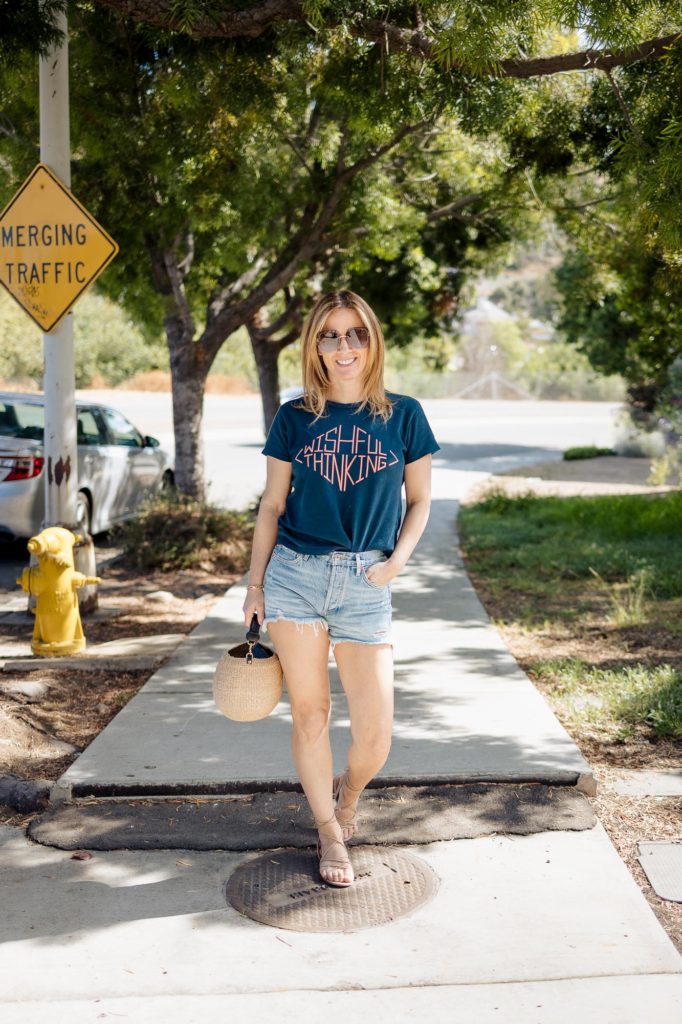 Wearing Mother graphic tshirt with Agolde shorts and Sam Edelman sandals.