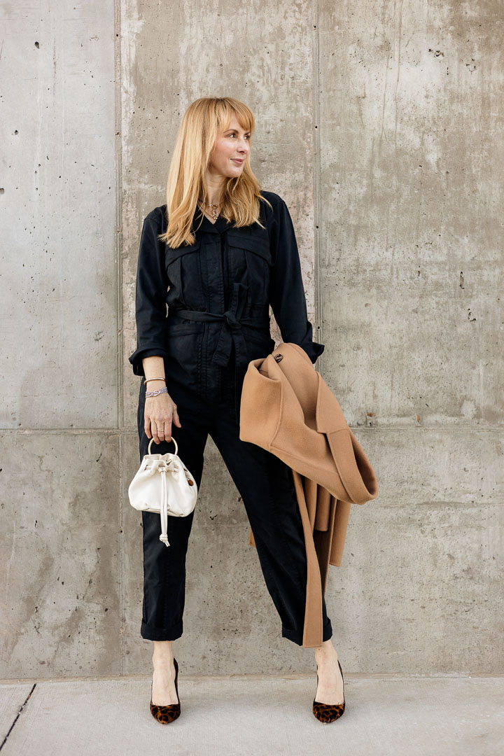 Wearing the Alex Mill Expedition Jumpsuit in washed black with the Anine Bing Dylan camel coat and ClareV ivory bag.