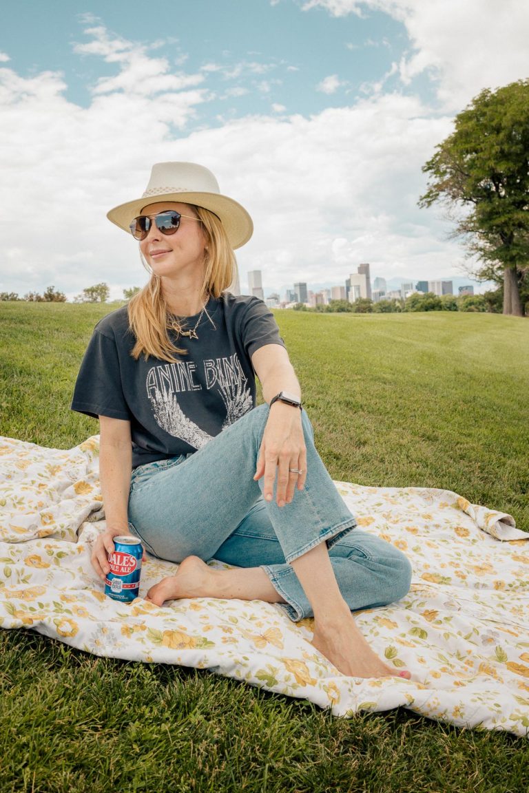 Wearing an Anine Bing graphic tee in washed black and cream Rag and Bone hat at the park.