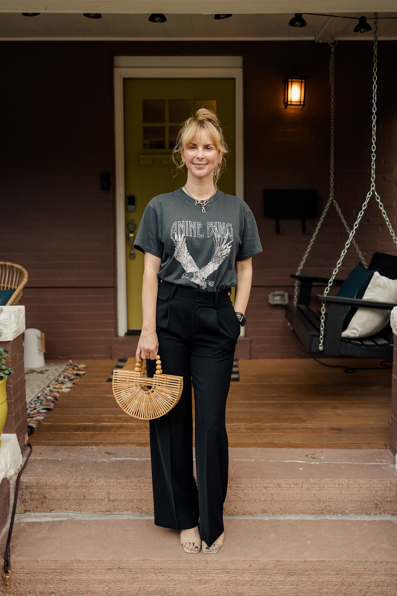 Wearing the Anine Bing lili tee in washed black with black Vince trousers and nude heels.
