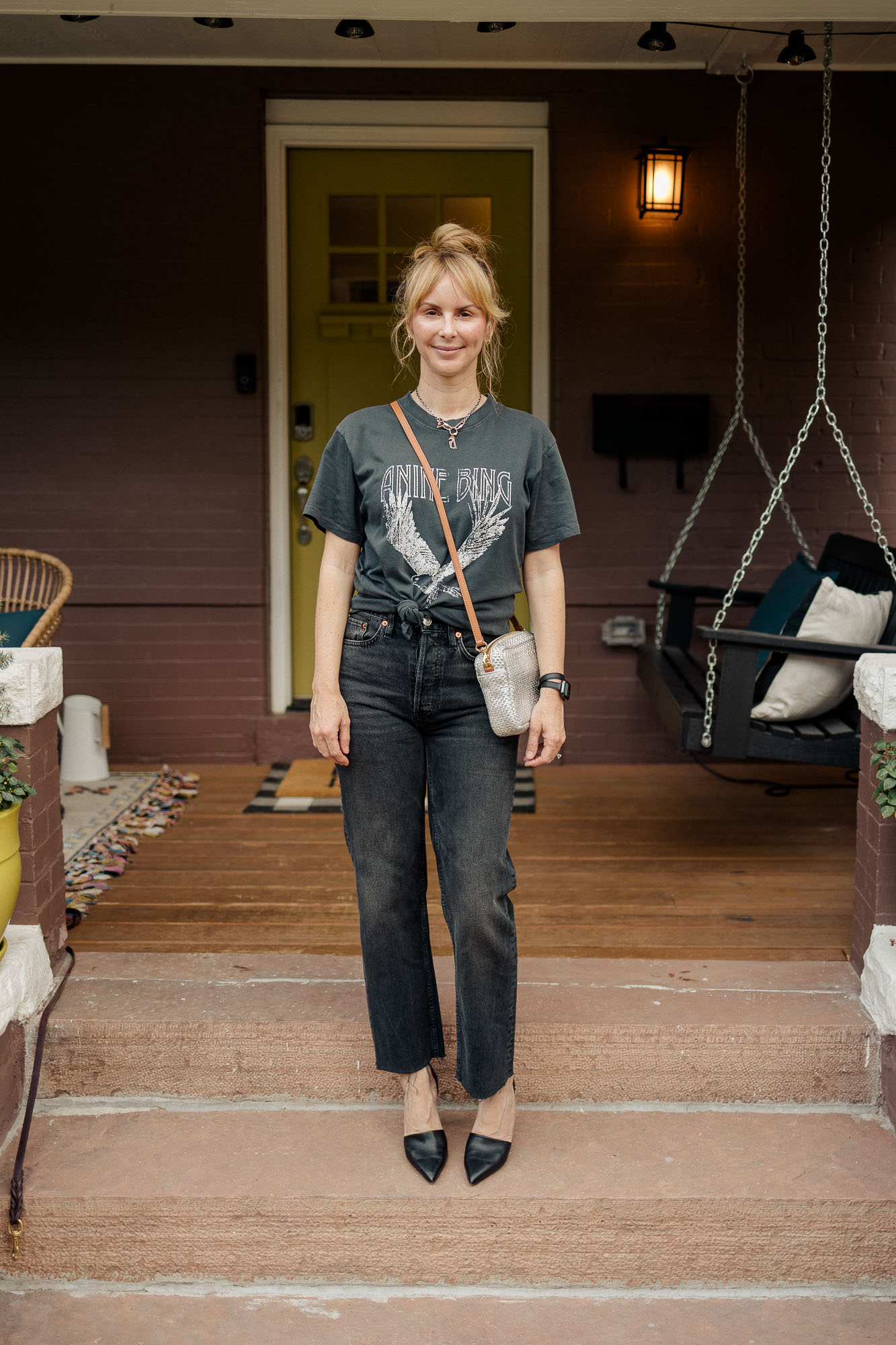 Wearing the washed black Anine Bing Lili tee with black Redone stovepipe jeans, black pumps and a silver Claire V bag.