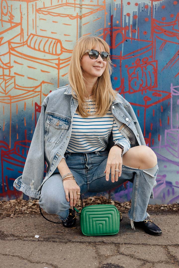 Wearing the Anine Bing Rory oversized denim jacket with a striped tee by KULE, Redone jeans, black Gucci loafers, and a green Clare V. bag.