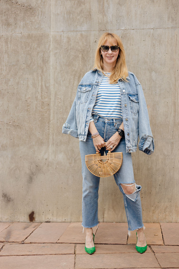 Wearing the Anine Bing Rory oversized denim jacket with a striped tee by KULE, Redone jeans, and green L'agence Eloise pumps.