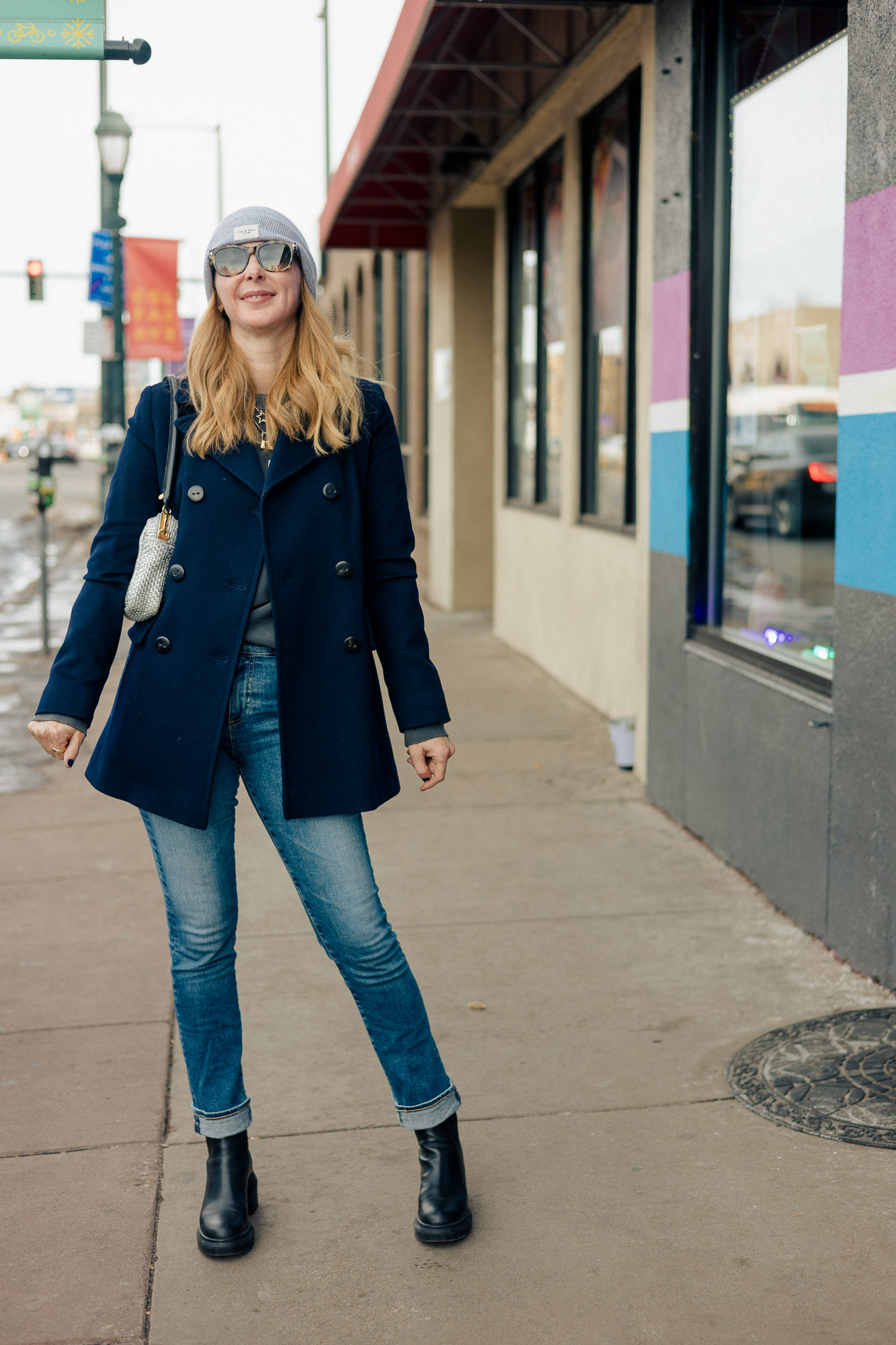 Wearing a navy Fleurette peacoat with a Rag and Bone beanie, AG jeans and Stuart Weitzman lug boots.