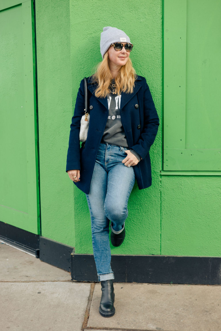 Wearing the Anine Bing New York sweatshirt with a navy Fleurette peacoat, AG jeans and black Stuart Weitzman lug boots.