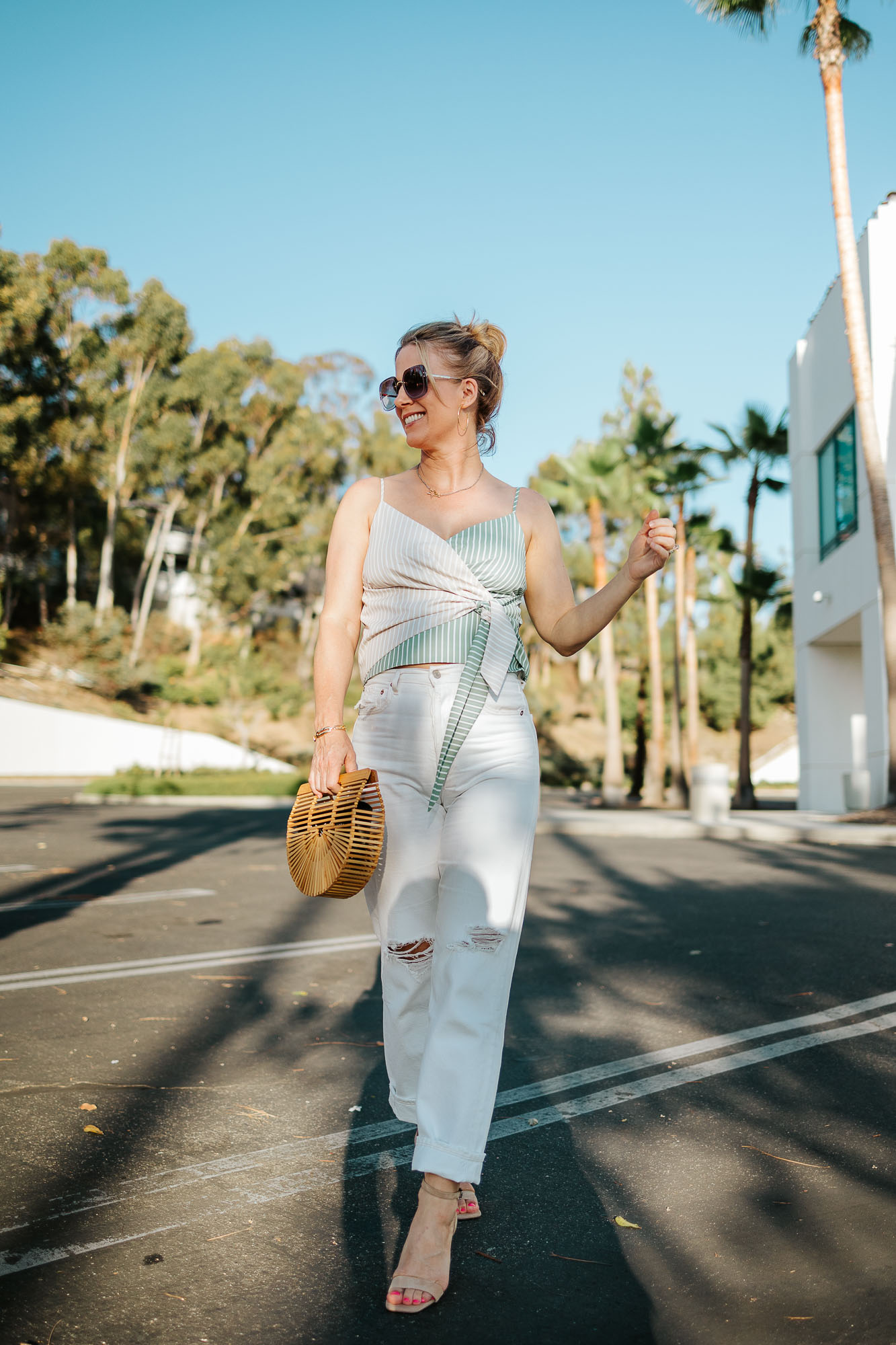 Wearing Cult Gaia Mini Ark, Vince Camuto Enella, Gorjana Taner Hoop Earrings, plus Agolde Jeans and Anthropologie tie-front top.