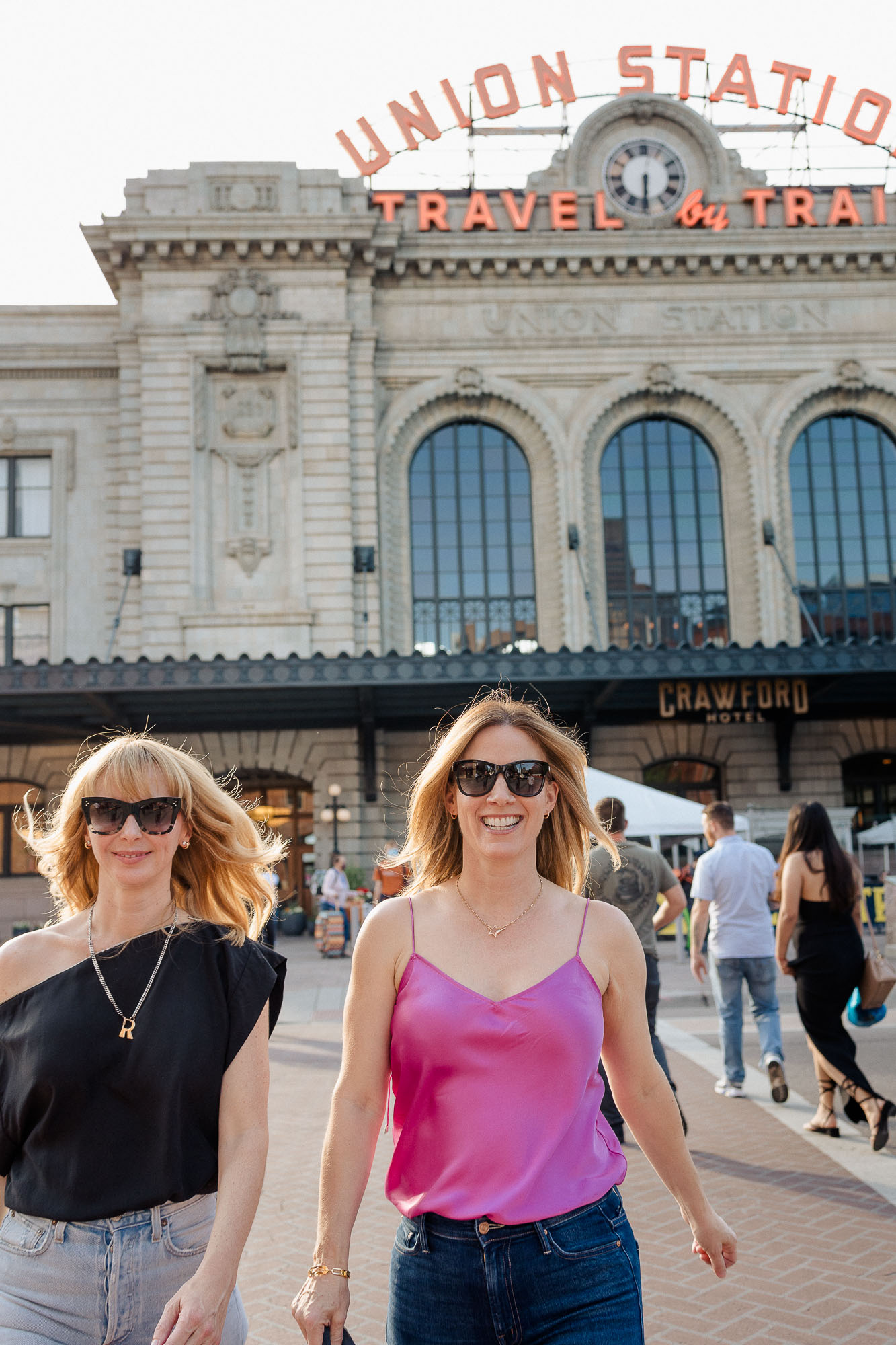 Saks Friends and Family Sale! Tammy & Rachel walking in front of Union Station wearing heels, jeans and sexy tops.