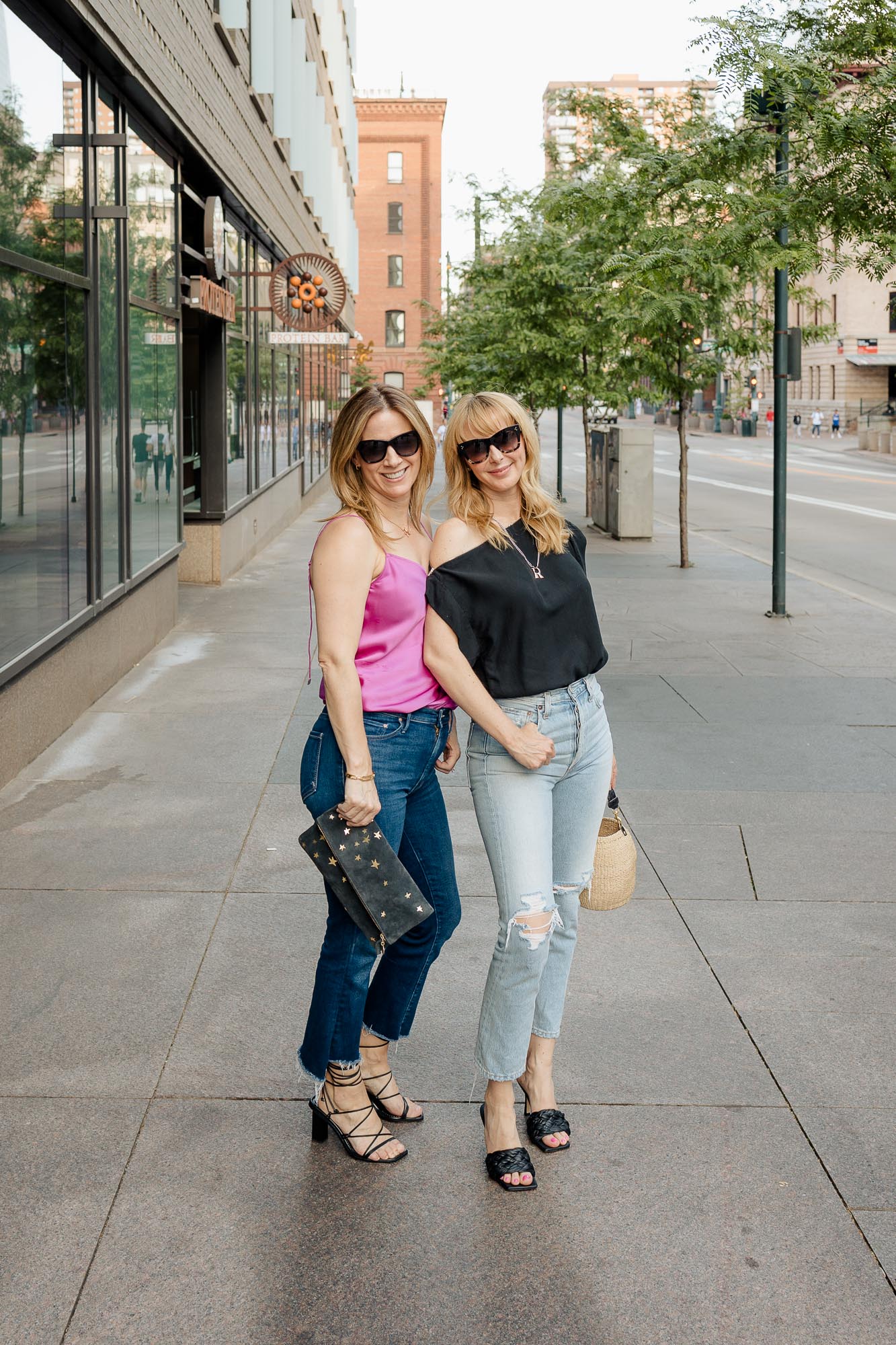 Tammy and Rachel in downtown Denver wearing pink Paige camisole and black Ninobrand top.