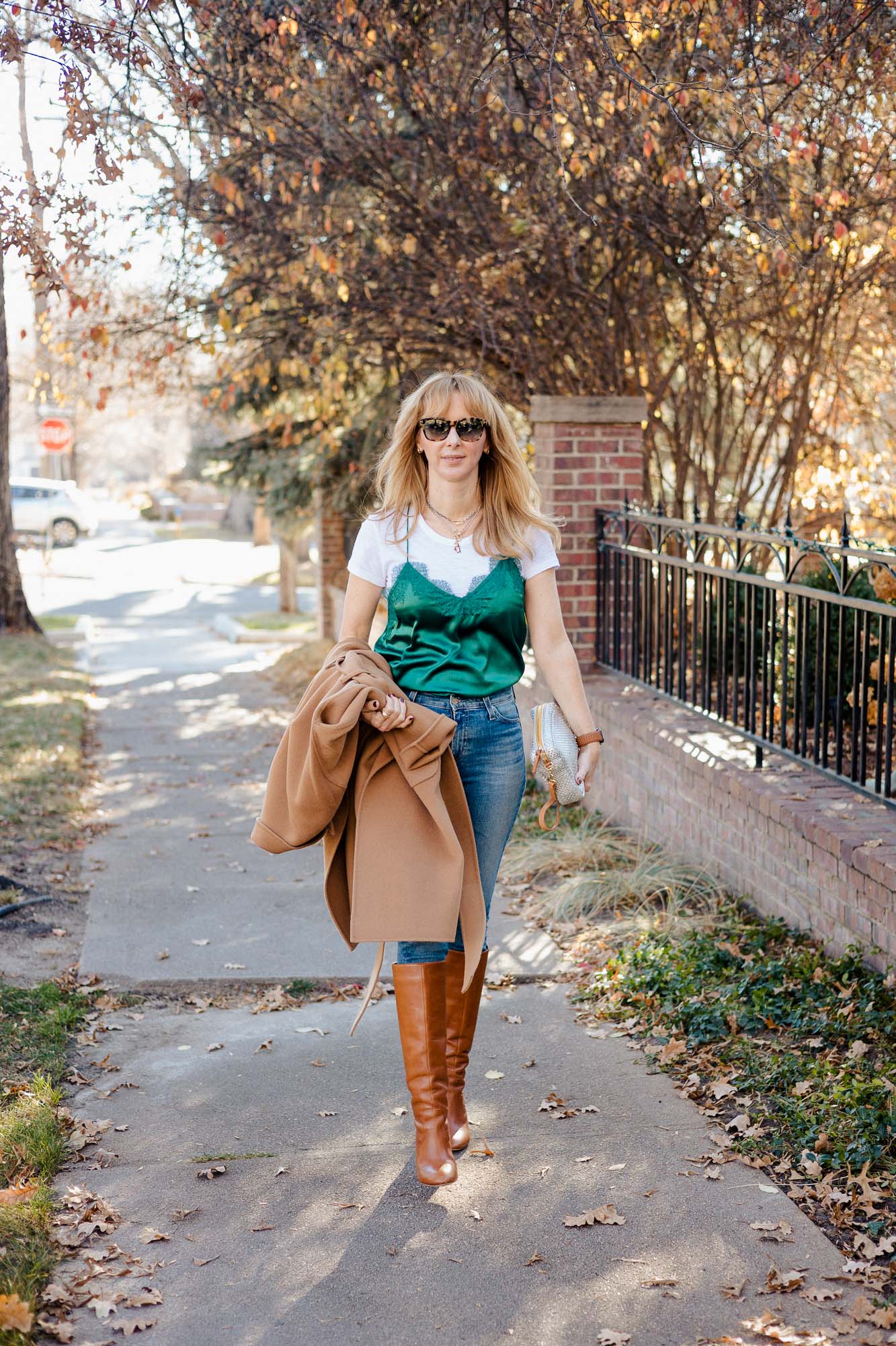 Wearing an emerald green Cami NYC camisole with jeans, Loeffler Randall gold boots and an Anine Bing camel coat.