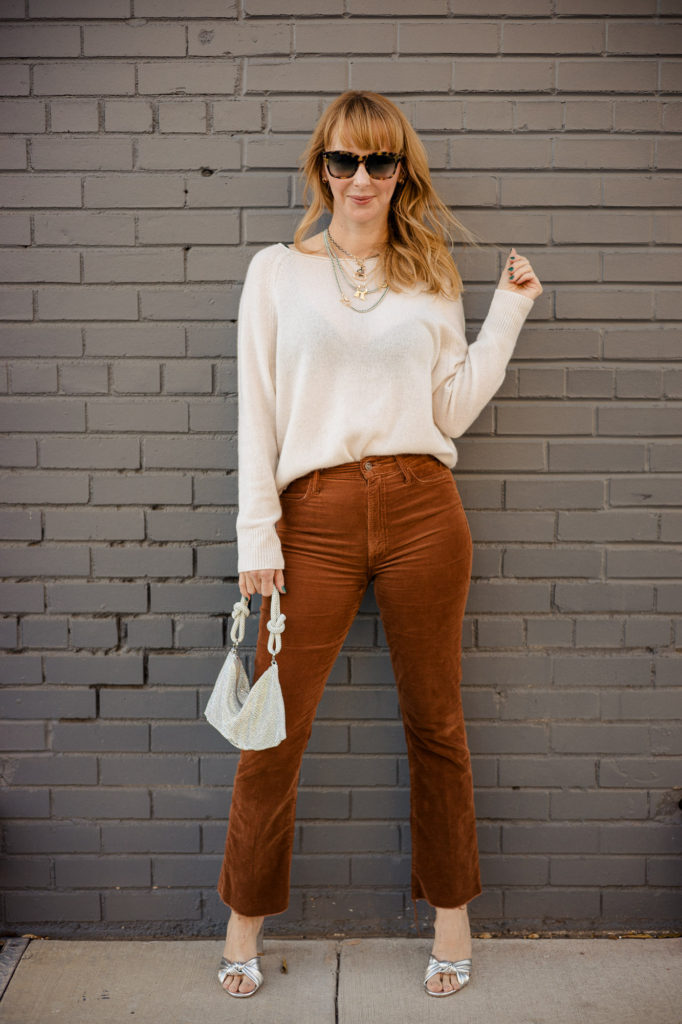Wearing an ivory Naked Cashmere sweater with brown Mother corduroy pants and silver veronica beard heels and Cult Gaia bag.