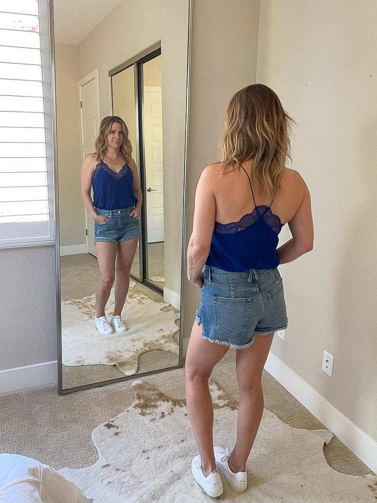 Wearing Good American cutoff shorts with Zadig and Voltaire silk camisole.