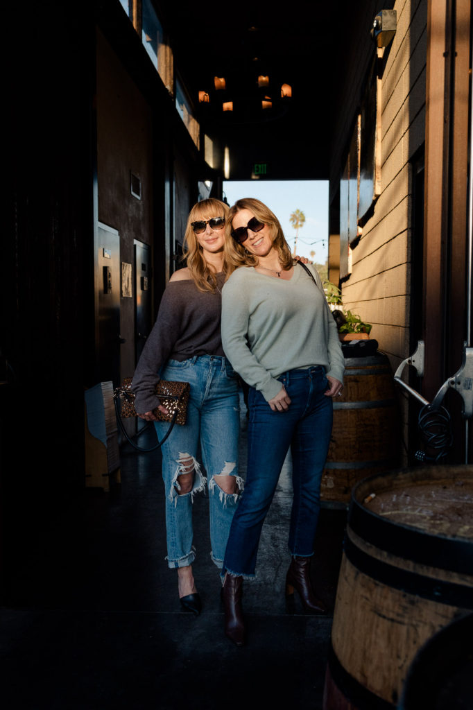 Tammy and Rachel wearing cashmere sweaters at a winery in San Diego.