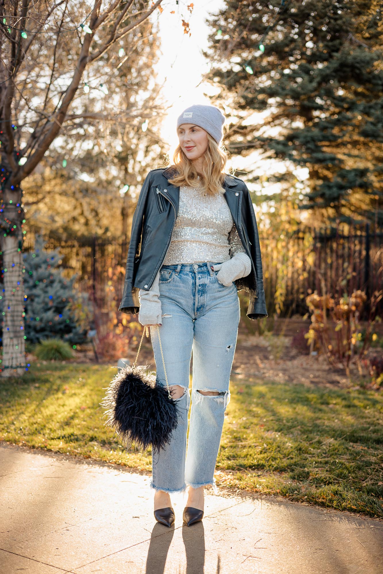 Wearing the free people sequin top in silver with Moussy Odessa jeans and a black Iro leather jacket.