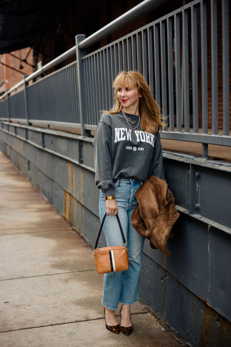 Wearing the Anine Bing New York sweatshirt with Mother jeans, L'agence leopard heels and a Clare V bag.