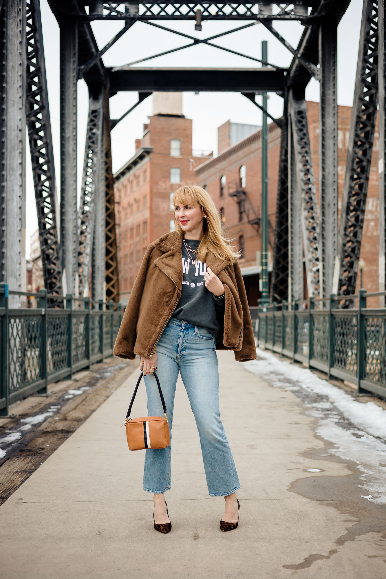 Wearing the Anine Bing New York sweatshirt with a Vince faux fur, Mother jeans, leopard L'agence pumps and a Clare V crossbody bag.