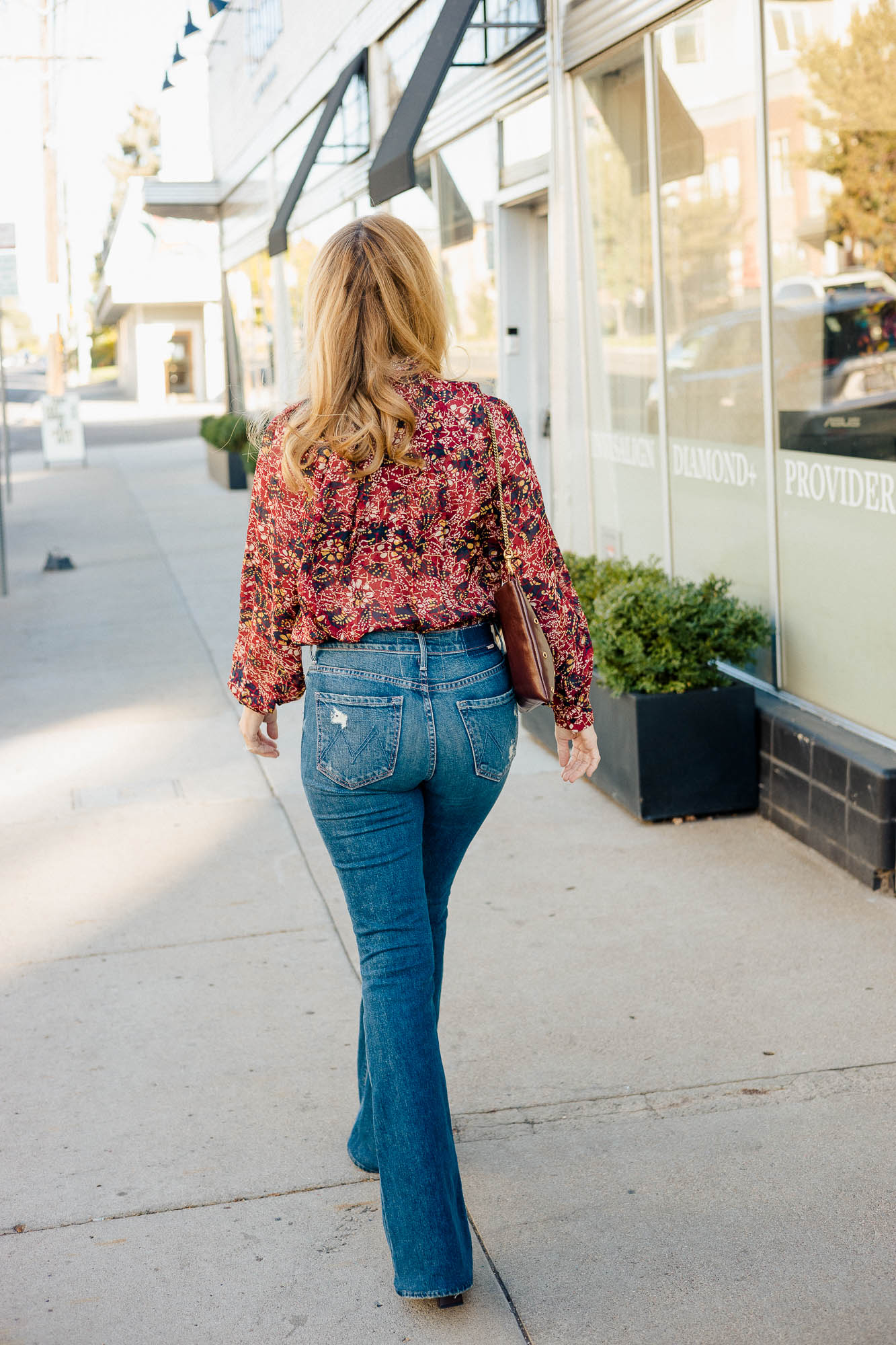 The back view of the Mother Super Cruiser Flare jeans and ba&sh fall blouse.