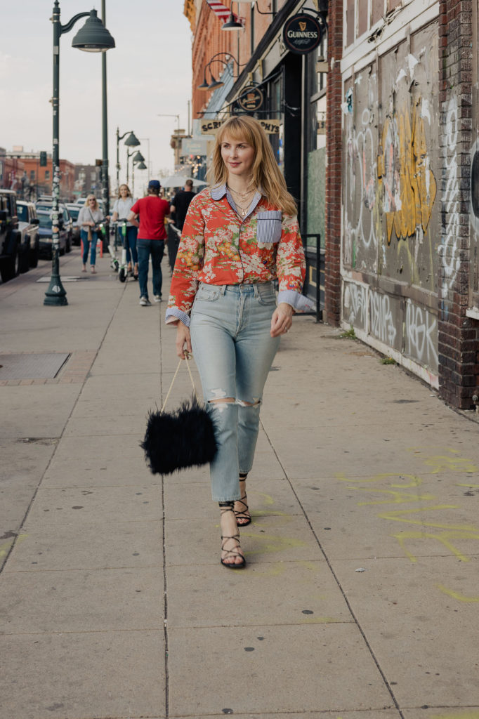 Wearing a red pajama top by West of Breakfast Agolde jeans and heels for a night out.