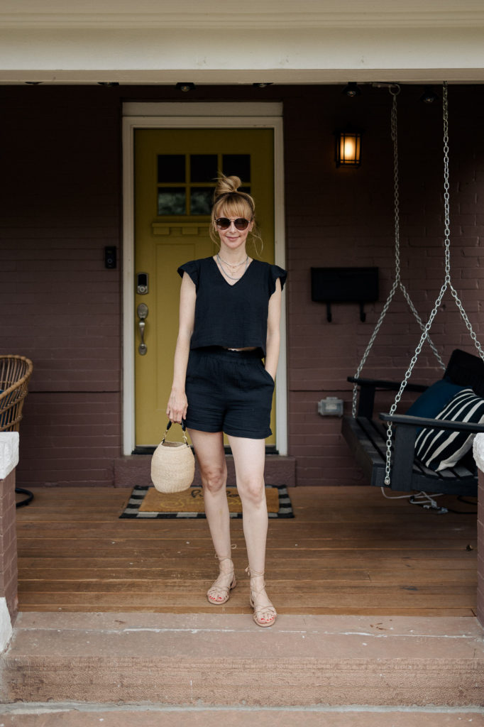 Wearing a black Rails short set with Sam Edelman strappy sandals and a Clare V woven bag.