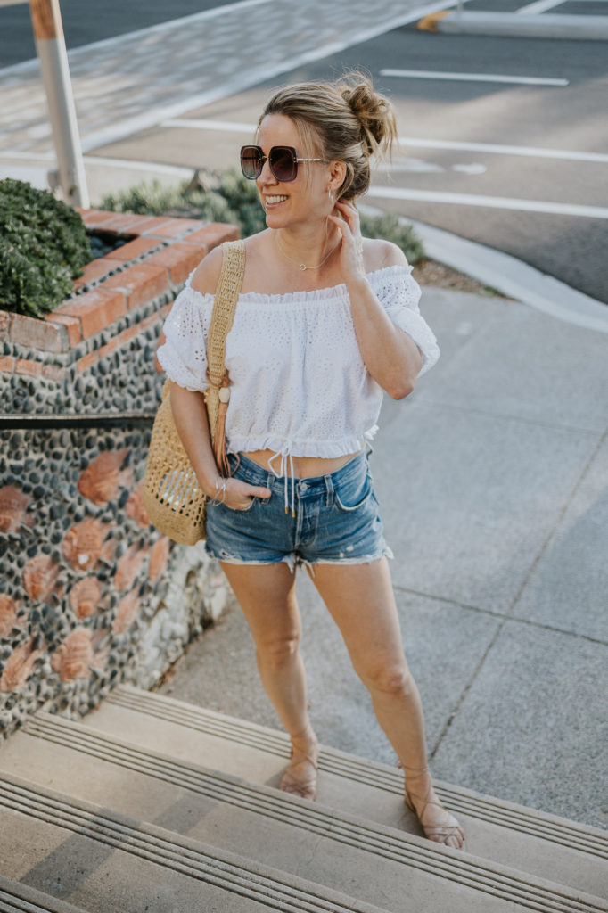 Beach outfit in southern california in cutoff shorts and off the shoulder top.