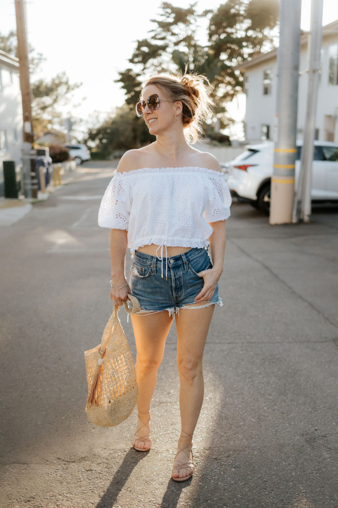 Southern California beach town in spring outfit of white top and cutoffs.