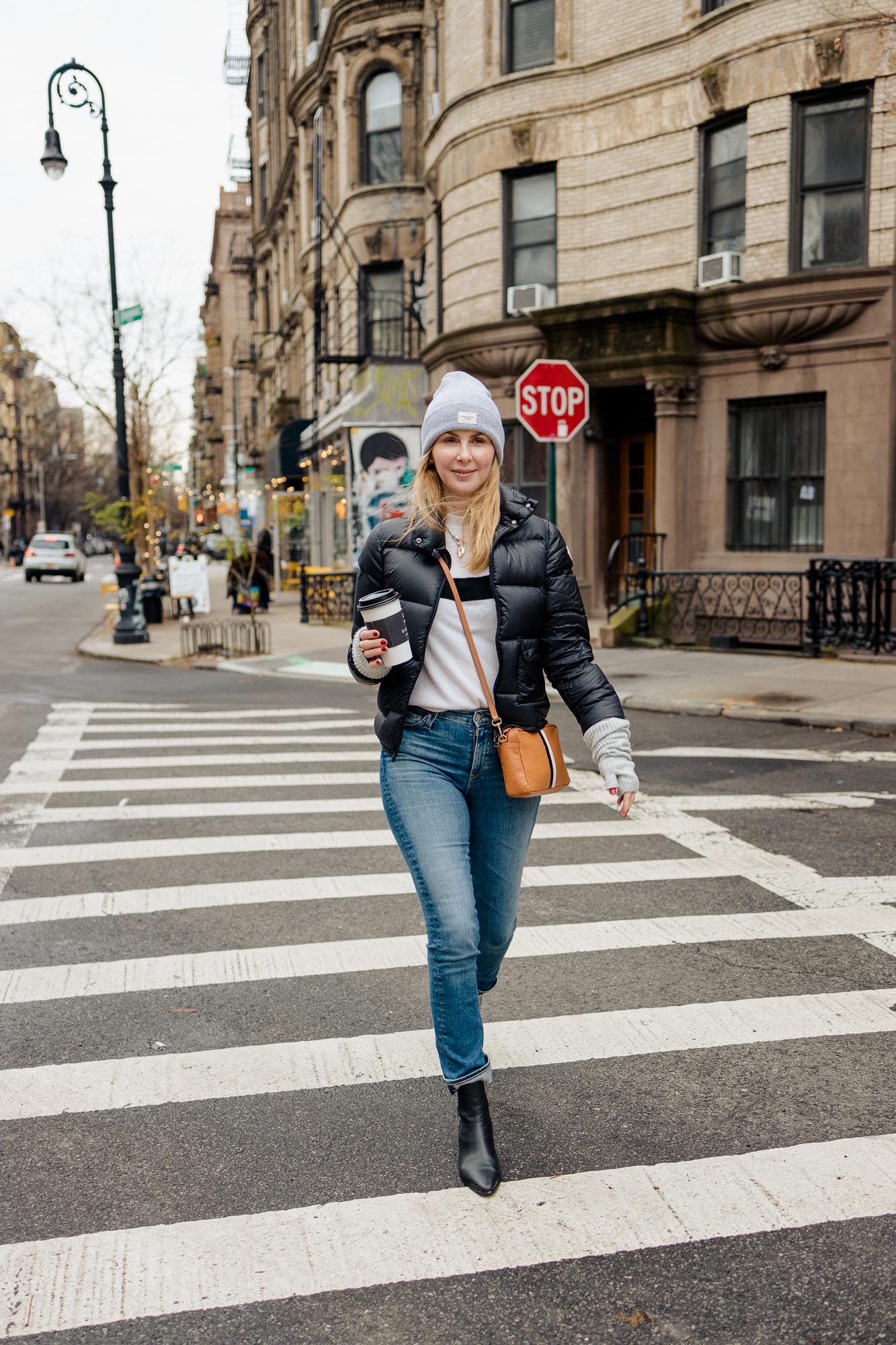 Wearing a Moncler puffer, cashmere Le Ligne sweater and AG jeans in New York City.