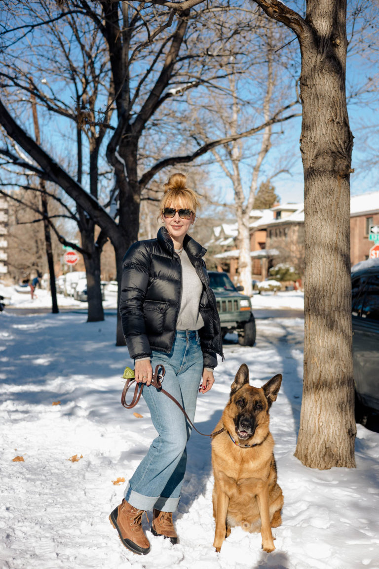 Wearing straight-leg relaxed jeans with snow boots while walking Rocky the German Shepherd.