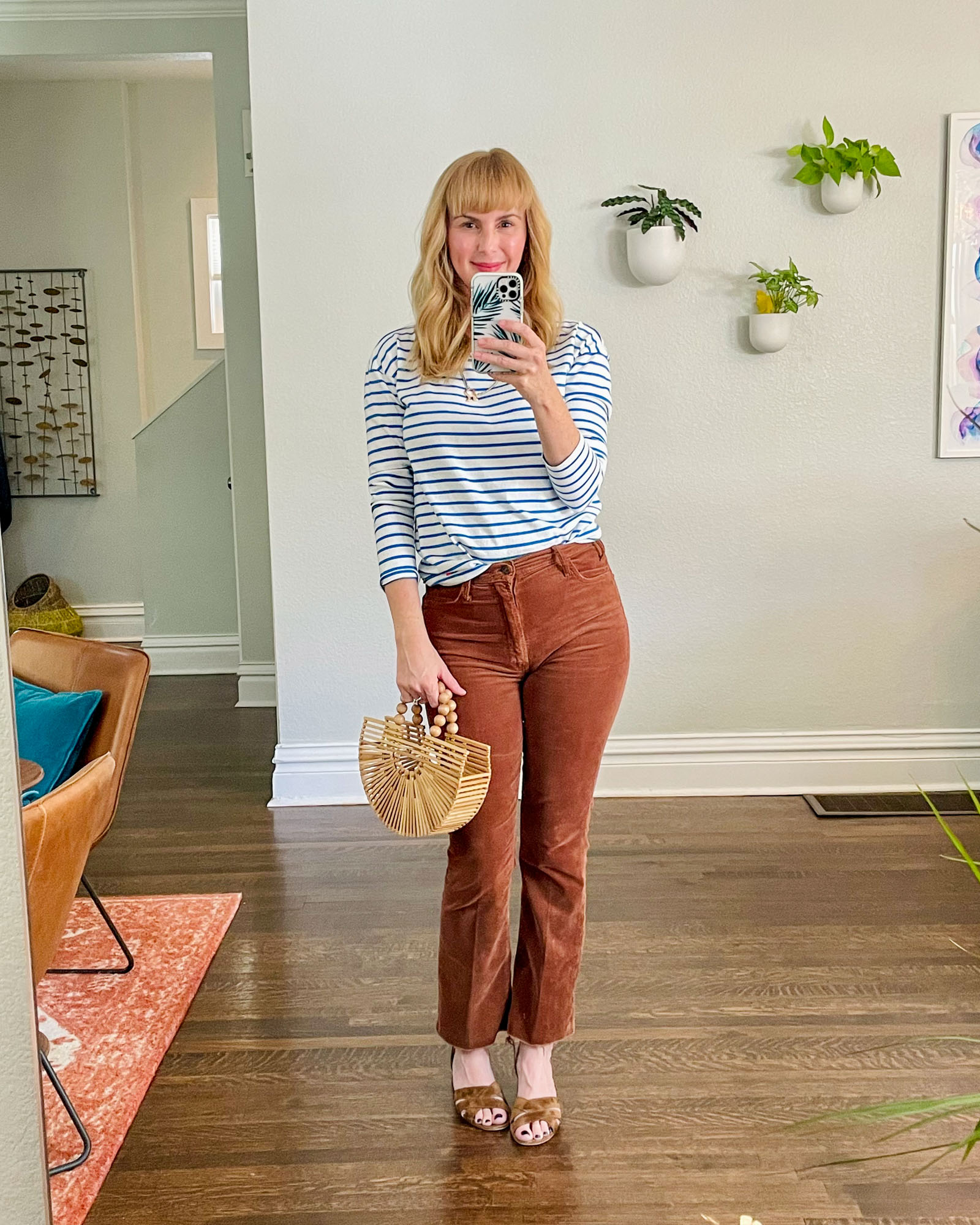 Wearing the Mother Hustler trousers in brown corduroy with a blue and white stripe tee by KULE and brown sandals.