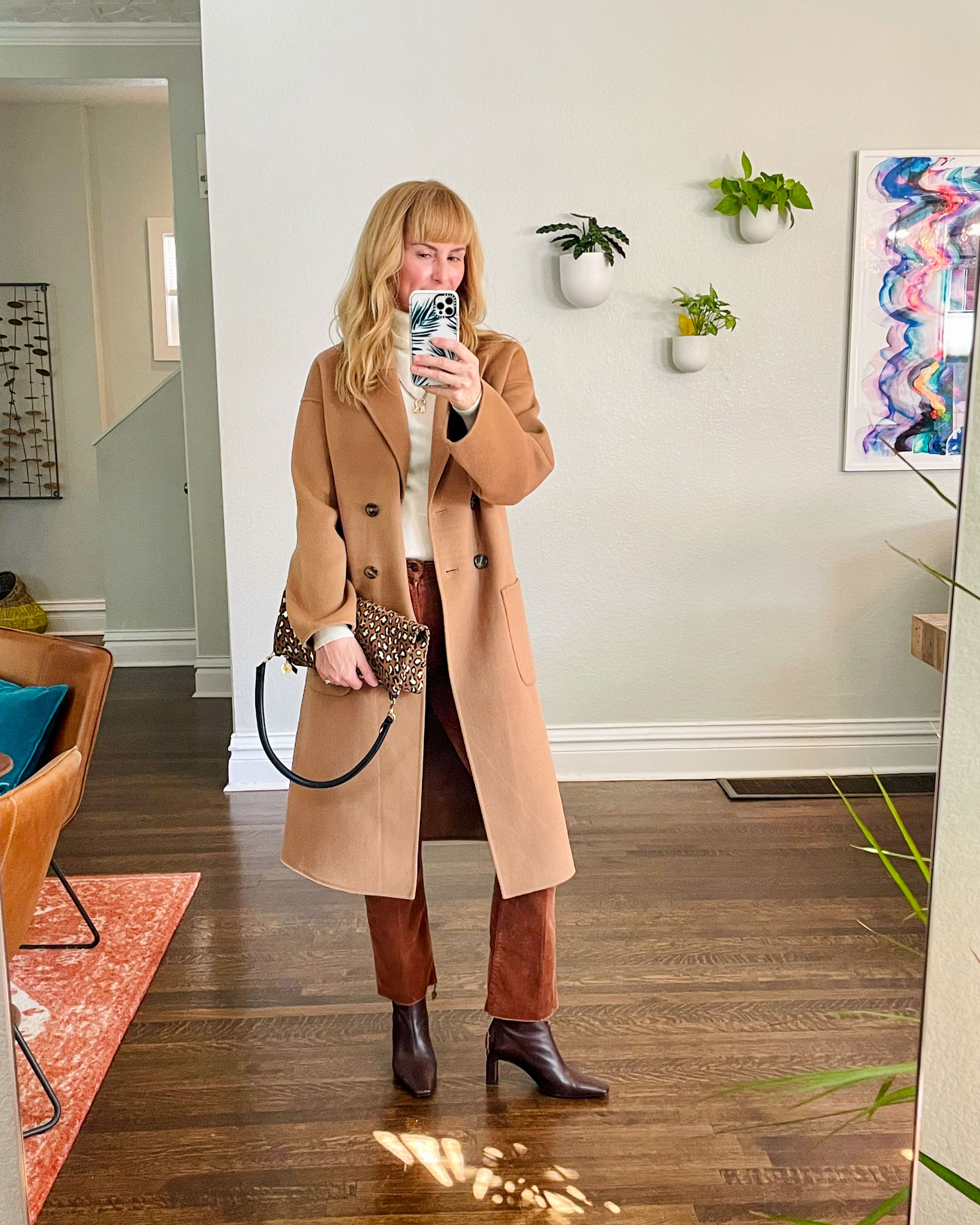 Wearing the Mother Huster trousers in brown with brown boots, a camel Anine Bing coat and a leopard Clare V bag.