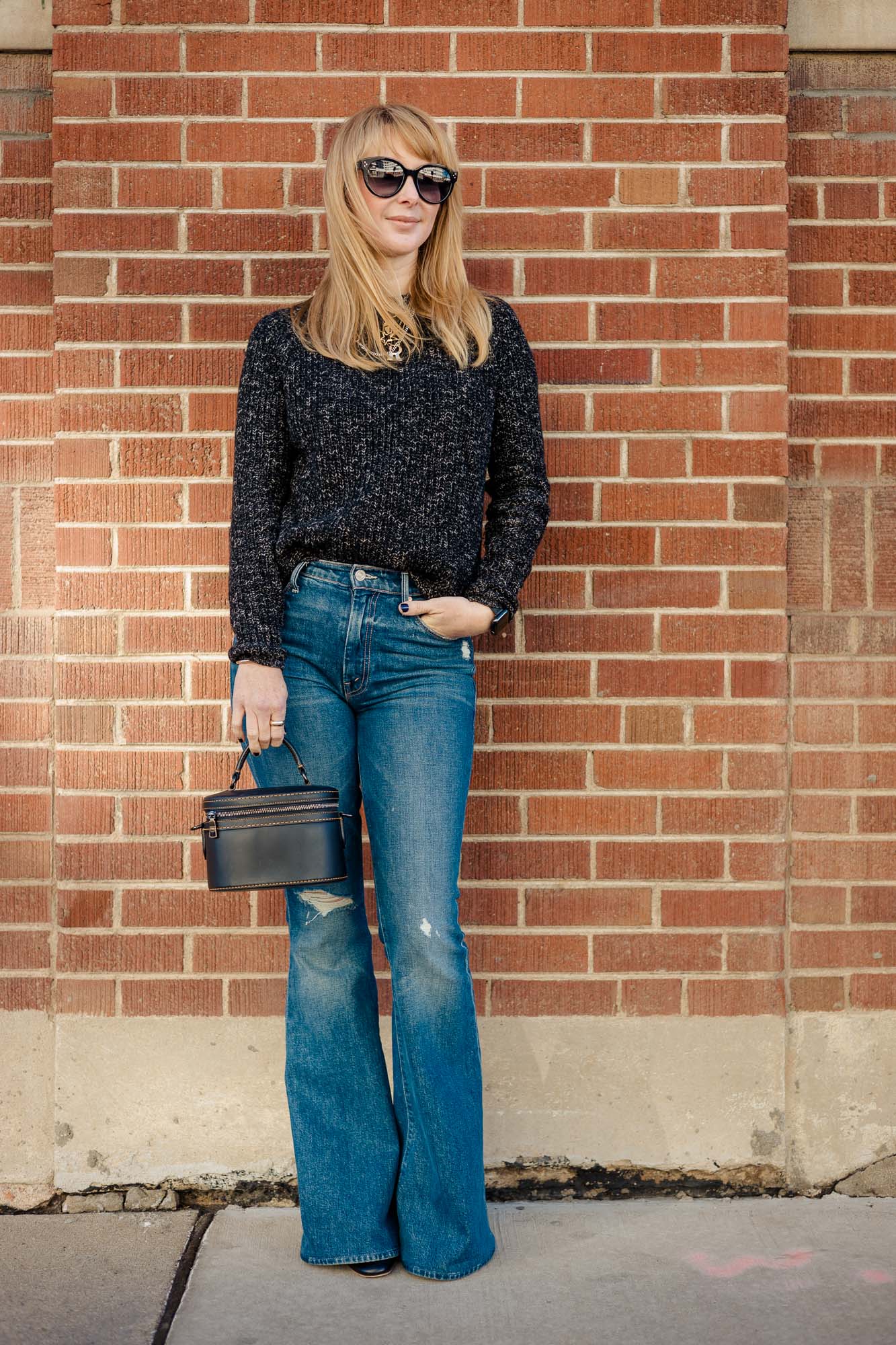 Wearing the Jenni Kayne cashmere fisherman sweater with mother flair jeans and a black Coach bag.