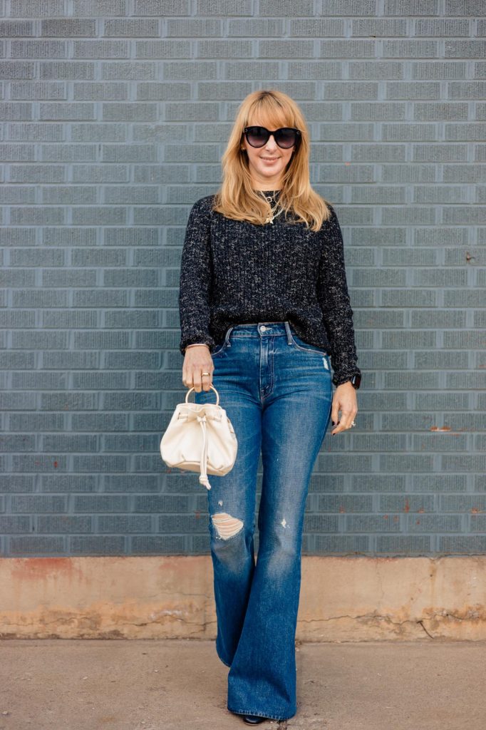 Wearing a black Jenni Kayne Fisherman sweater with mother jeans and the ivory Clare V Grace bag.