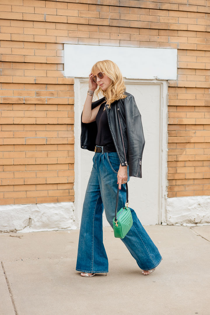 Wearing Nili Lotan Flora Jeans with an Anthony ATM camisole, belt, green Clare V bag and Iro leather jacket.