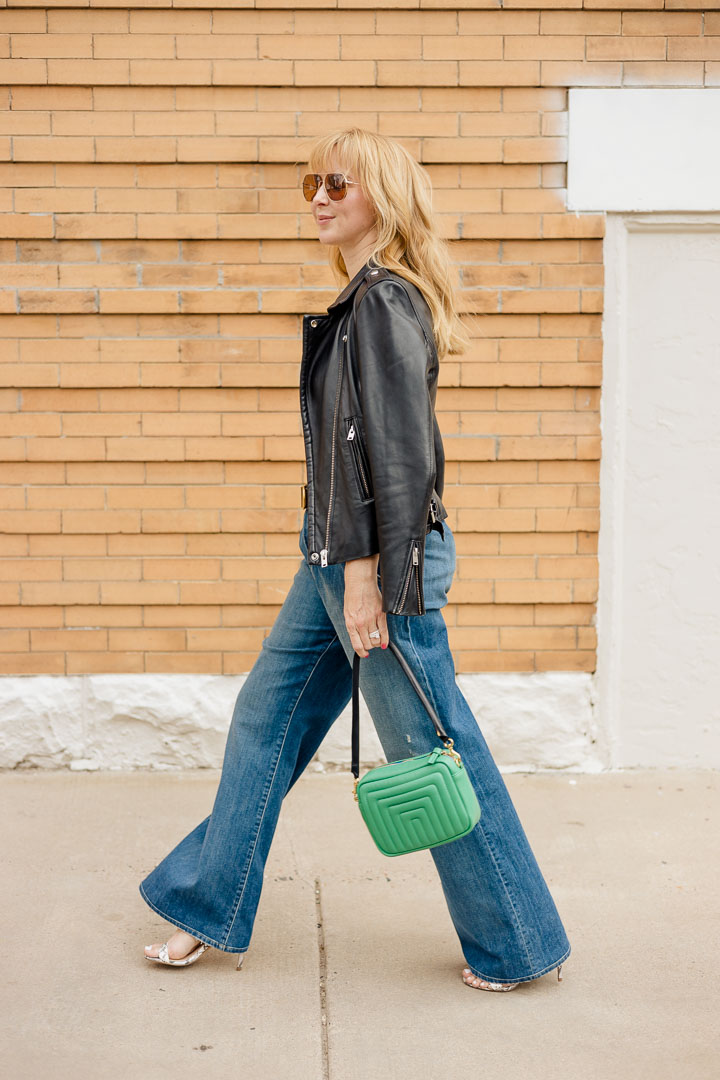 Wearing Nili Lotan Flora Jeans with an Anthony ATM camisole, belt, green Clare V bag and Iro leather jacket.