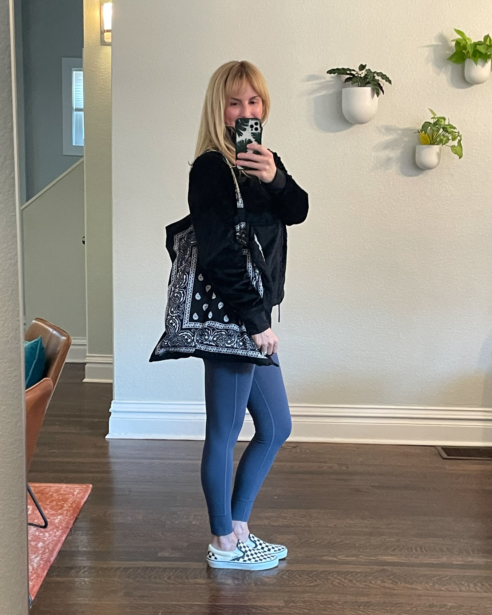 Wearing the North Face Osito fleece in black from the Nordstrom Anniversary sale with leggings and vans checked sneakers.