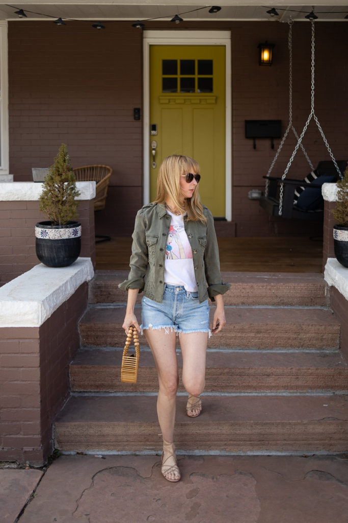 An amazing summer outfit is the Paige Pacey jacket in green, Re/done graphic tee, Agolde vintage parker shorts, Sam Edelman sandals and cult and gaia ark bag.
