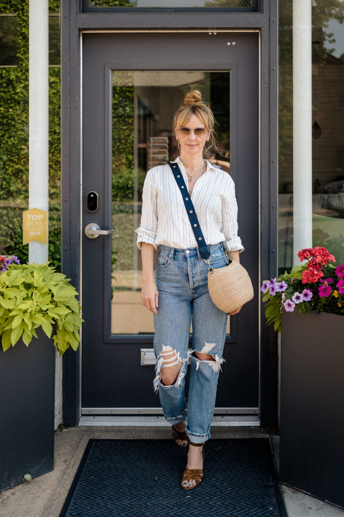 Wearing a stripe linen Reformation top with distressed Agolde loose 90s jeans.