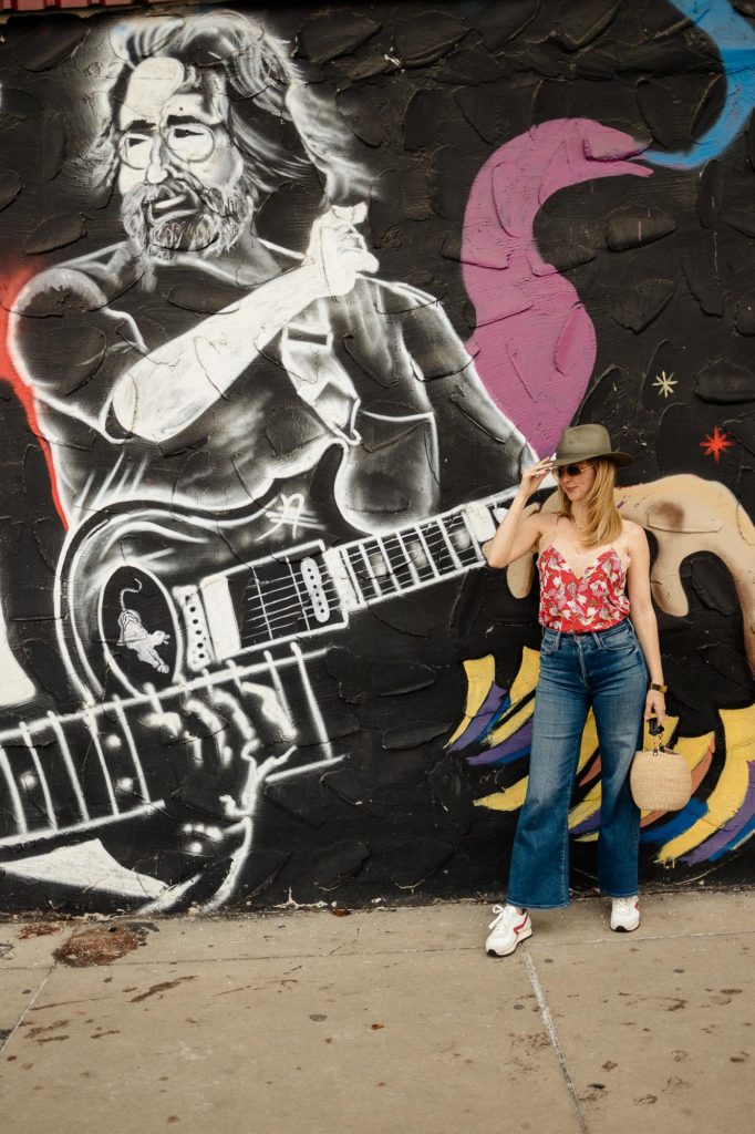 Standing by a Grateful Dead mural wearing my green Rag and Bone fedora and red silk Zadig Voltaire camisole.