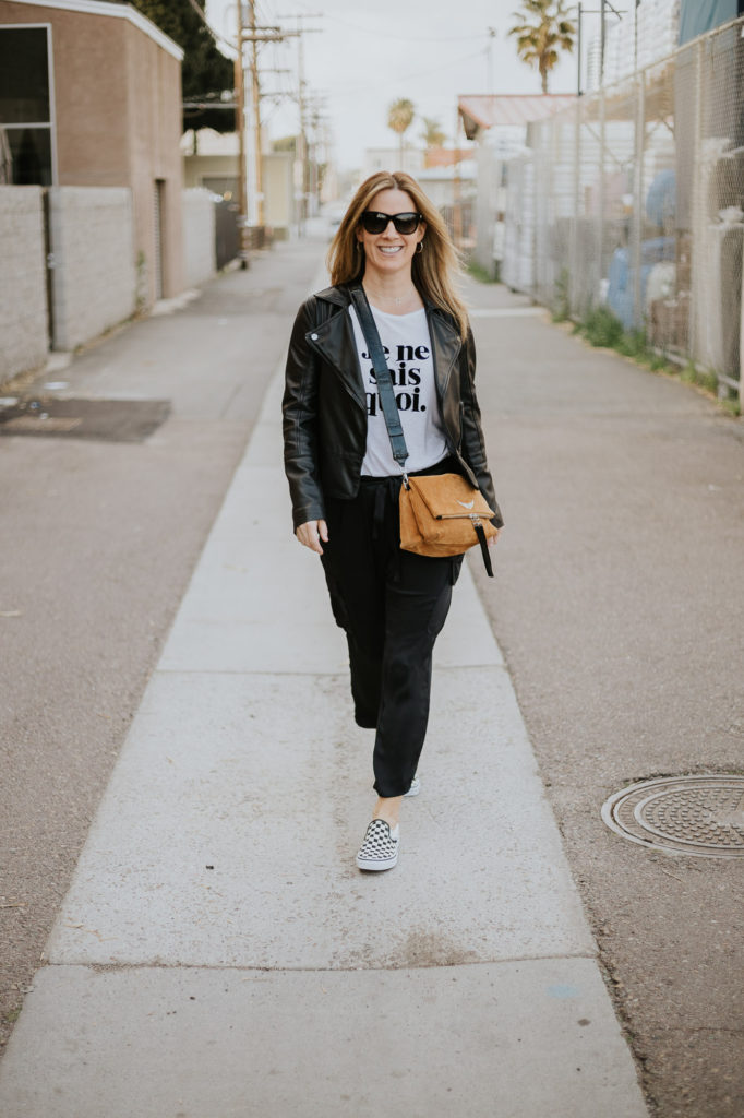 Leather jacket paired with Ramy Brook satin cargo pants and Zadig and Voltaire Je Ne Sais Quois t-shirt and bag plus cool checkerboard Vans sneakers.