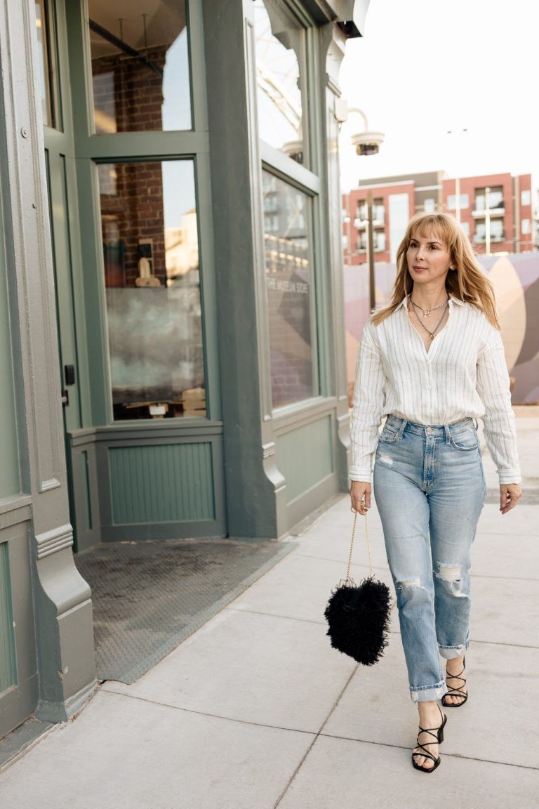 A date night look with Reformation linen button down, Mother Rider Skimp jeans, Frame Le Doheny black sandals (included in Saks Fifth Avenue Sale) and black feather bag.