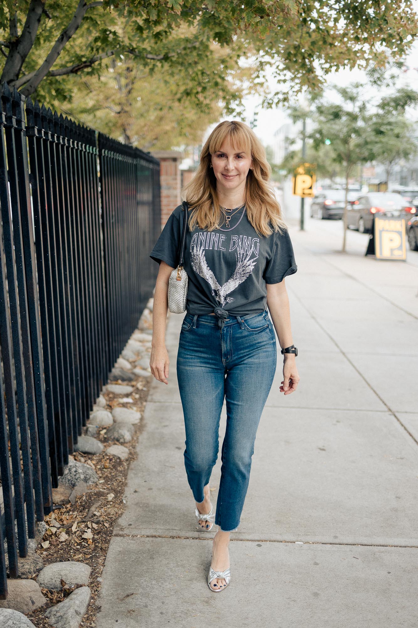 Wearing the Anine Bing washed black eagle graphic tee with Mother jeans and silver pumps.