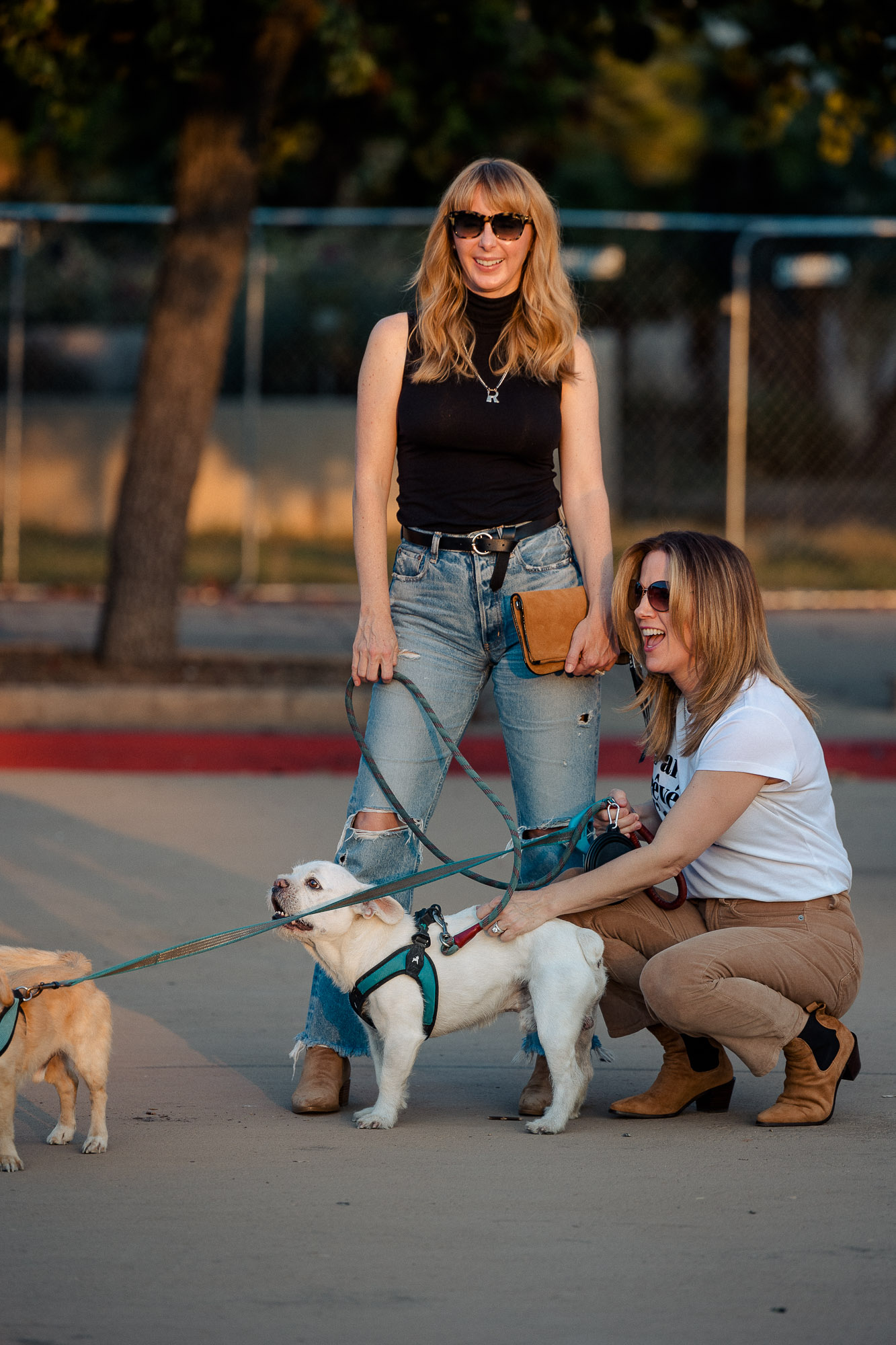 Wearing a black sleeveless theory turtleneck with Moussy Odessa jeans playing with dogs at Balboa Park.
