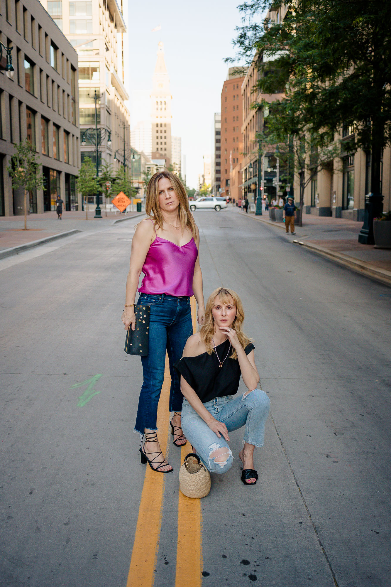Tammy and Rachel model pose in the middle of the street wearing pink Paige camisole and black off the shoulder top.